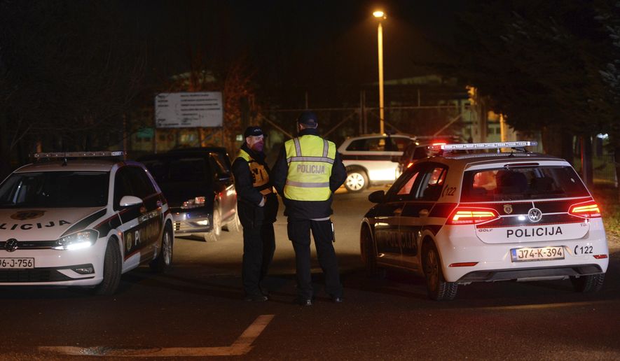 Bosnian police officers guard at the entrance of the airport in the capital Sarajevo, Bosnia, Thursday, Dec. 19, 2019. Bosnian authorities said Thursday that a group of 25 Bosnian citizens have been sent back to Bosnia from camps in Syria, including former Islamic State fighters but also women and children. (AP Photo/Kemal Softic)