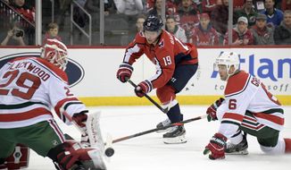 New Jersey Devils goaltender Mackenzie Blackwood (29) deflects a shot by Washington Capitals center Nicklas Backstrom (19) as Devils defenseman Andy Greene (6) also defends during the first period of an NHL hockey game Friday, Dec. 20, 2019, in Newark, N.J. (AP Photo/Bill Kostroun)