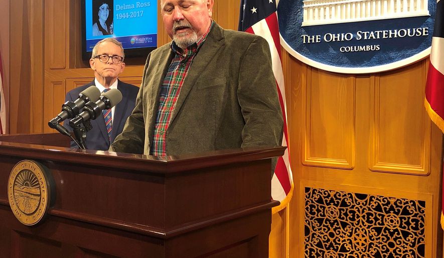 Terry Dawson, right, the son-in-law of a woman killed by a distracted driver in central Ohio on Christmas Eve 2017, describes how that accident has affected his family and made holidays much harder, at a news conference also attended by Ohio Gov. Mike DeWine, on Friday, Dec. 20, 2019, in Columbus, Ohio. DeWine said he wants distracted driving made a primary offense and promised a legislative proposal soon. (AP Photo/Andrew Welsh-Huggins)