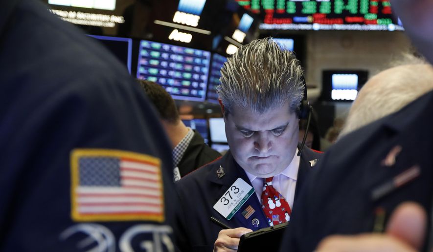 FILE - In this Dec. 13, 2019, file photo trader John Panin works on the floor of the New York Stock Exchange. The U.S. stock market opens at 9:30 a.m. EST on Friday, Dec. 20. (AP Photo/Richard Drew, File)