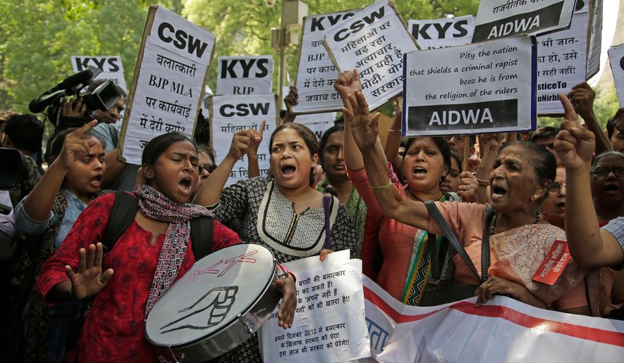 FILE - In this Thursday, April 12, 2018 file photo, Indian students and activists participate in a protest against recent cases of rape in the country, including one where the accused is a governing Hindu nationalist party lawmaker Kuldeep Singh Sengar, in New Delhi, India. An Indian court sentenced the lawmaker from the governing party on Friday, Dec. 20, to life in prison after finding him guilty of abducting and raping a minor girl in 2017. (AP Photo/Altaf Qadri, File)