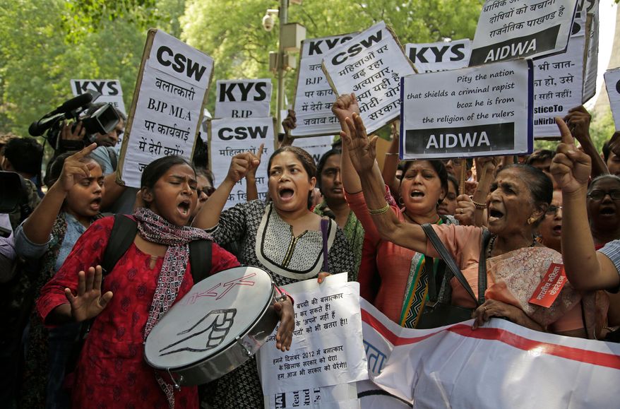 FILE - In this Thursday, April 12, 2018 file photo, Indian students and activists participate in a protest against recent cases of rape in the country, including one where the accused is a governing Hindu nationalist party lawmaker Kuldeep Singh Sengar, in New Delhi, India. An Indian court sentenced the lawmaker from the governing party on Friday, Dec. 20, to life in prison after finding him guilty of abducting and raping a minor girl in 2017. (AP Photo/Altaf Qadri, File)