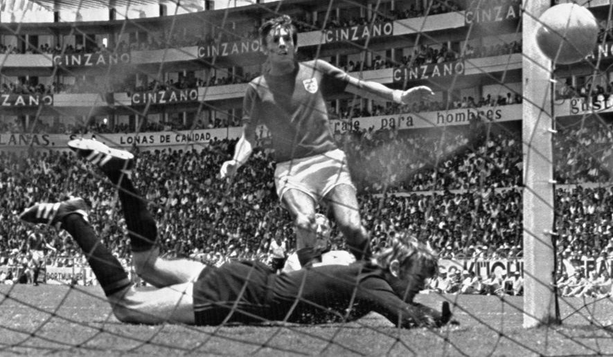 FILE - In this June 14, 1970 file photo, England's Martin Peters scores his country's second goal in the world cup quarter final against West Germany at Leon, Mexico. Peters, who scored one of England's goals in its victory over West Germany in the 1966 World Cup final, has died after a long battle with Alzheimer's disease. He was 76. Peters' family announced his death on Saturday, Dec. 21, 2019 via a statement through English soccer club West Ham, saying he passed away peacefully in his sleep. (AP Photo, File)