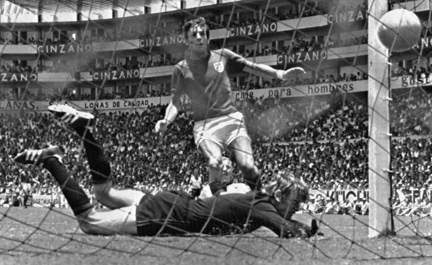 FILE - In this June 14, 1970 file photo, England's Martin Peters scores his country's second goal in the world cup quarter final against West Germany at Leon, Mexico. Peters, who scored one of England's goals in its victory over West Germany in the 1966 World Cup final, has died after a long battle with Alzheimer's disease. He was 76. Peters' family announced his death on Saturday, Dec. 21, 2019 via a statement through English soccer club West Ham, saying he passed away peacefully in his sleep. (AP Photo, File)