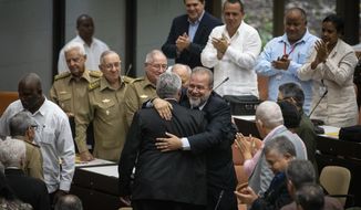 Cuban Prime Minister Manuel Marrero Cruz embraces Cuba&#39;s President Miguel Diaz-Canel during the closing session at the National Assembly of Popular Power in Havana, Cuba, Saturday, Dec. 21, 2019.  Diaz-Canel named the former Tourism Marrero Cruz as the country&#39;s first prime minister since 1976. (AP Photo/Ramon Espinosa)
