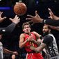 Atlanta Hawks guard Trae Young (11) passes the ball away from Brooklyn Nets forward Wilson Chandler during the first half of an NBA basketball game Saturday, Dec. 21, 2019, in New York. (AP Photo/Noah K. Murray)