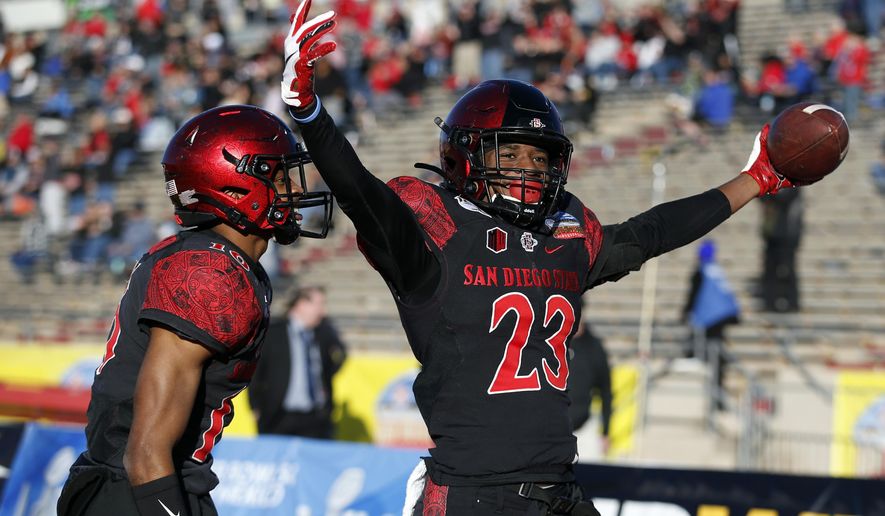 San Diego State cornerback Darren Hall (23) celebrates with teammate Luq Barcoo after scoring a touchdown on a Central Michigan fumble return during the second half of the New Mexico Bowl NCAA college football game on Saturday, Dec. 21, 2019 in Albuquerque, N.M. (AP Photo/Andres Leighton)