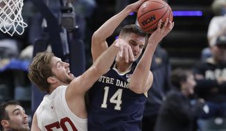 Notre Dame&#39;s Nate Laszewski (14) grabs a rebound from Indiana&#39;s Joey Brunk (50) during the first half of an NCAA college basketball game, Saturday, Dec. 21, 2019. (AP Photo/Darron Cummings)