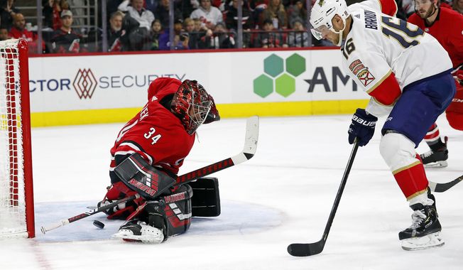 Florida Panthers&#x27; Aleksander Barkov (16), of Finland, gets the puck past Carolina Hurricanes goaltender Petr Mrazek (34), of the Czech Republic, but it bounces off the post during the second period of an NHL hockey game in Raleigh, N.C., Saturday, Dec. 21, 2019. (AP Photo/Karl B DeBlaker)