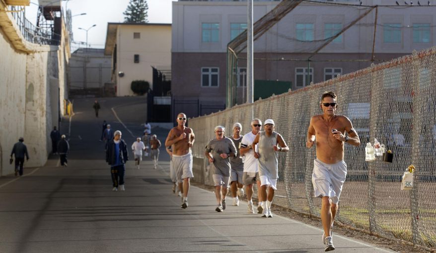 FILE - In this Friday, Nov. 22, 2019 file photo, Mark Alan Jarosik, front right, participates in the San Quentin State Prison marathon in San Quentin, Calif. Aged 22 to 72, the competitors are all members of the maximum-security prison’s 1,000 Mile Club and include inmates incarcerated for rape, attempted murder and other charges. (Santiago Mejia/San Francisco Chronicle via AP)/San Francisco Chronicle via AP)