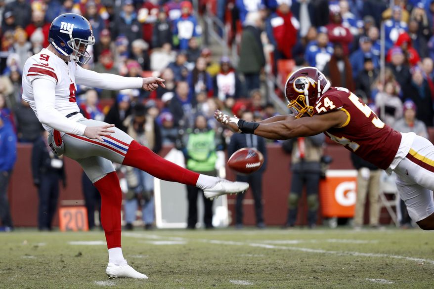 Washington Redskins linebacker Nate Orchard, right, blocks a punt attempt by New York Giants punter Riley Dixon during the second half of an NFL football game, Sunday, Dec. 22, 2019, in Landover, Md. (AP Photo/Patrick Semansky) **FILE**