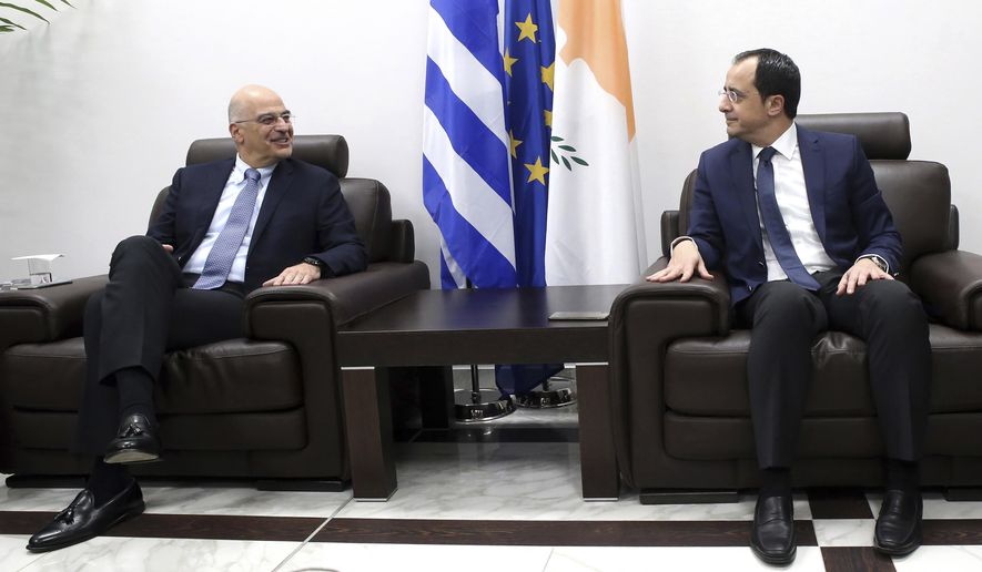 Greece&#x27;s Foreign Minister Nikos Dendias, left, talks with Cypriot counterpart Nikos Christodoulides at Cyprus&#x27; main airport in the coastal town of Larnaca on Sunday, December 22, 2019. Dendias stopped off in Cyprus following a visit to Libya for contacts with Libyan National Army leader, General Khalifa Haftar and later in Egypt for a meeting with Foreign Minister Sameh Shoukry. Top of the agenda during Dendias&#x27; contacts was a maritime border deal that Turkey signed with Libya&#x27;s U.N.-recognized government that Greece, Cyprus and Egypt have denounced as contrary to international law.(AP Photo/Philippos Christou)