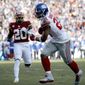 New York Giants running back Saquon Barkley, right, catches a touchdown pass from quarterback Daniel Jones, not visible, as Washington Redskins strong safety Landon Collins (20) tries to defend during the first half of an NFL football game, Sunday, Dec. 22, 2019, in Landover, Md. (AP Photo/Patrick Semansky)