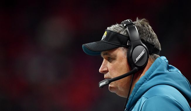 Jacksonville Jaguars head coach Doug Marrone works during the second half of an NFL football game against the Atlanta Falcons, Sunday, Dec. 22, 2019, in Atlanta. (AP Photo/John Amis)