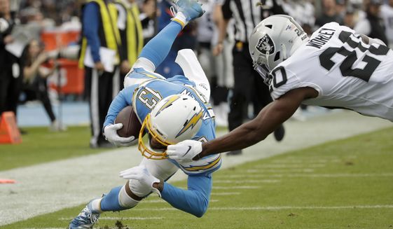 Oakland Raiders cornerback Daryl Worley, right, tackles Los Angeles Chargers wide receiver Keenan Allen short of the goal line during the second half of an NFL football game Sunday, Dec. 22, 2019, in Carson, Calif. (AP Photo/Marcio Jose Sanchez)