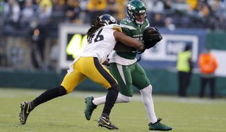 New York Jets running back Le&#39;Veon Bell (26) runs with the ball under pressure from Pittsburgh Steelers inside linebacker Mark Barron (26) in the second half of an NFL football game, Sunday, Dec. 22, 2019, in East Rutherford, N.J. (AP Photo/Adam Hunger)