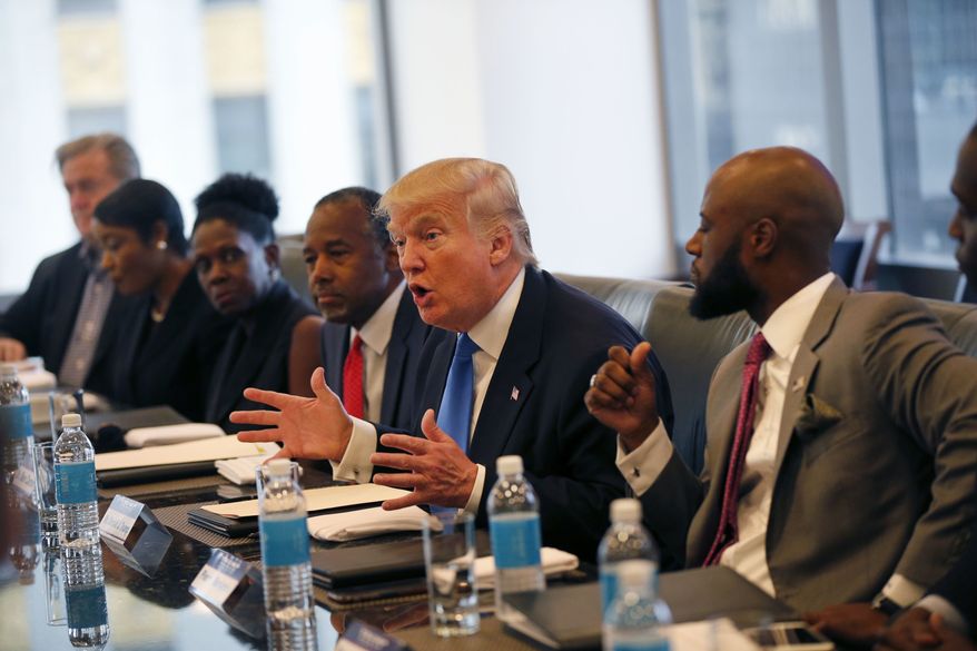 In this Aug. 25, 2016, file photo, Republican presidential candidate Donald Trump holds a roundtable meeting with the Republican Leadership Initiative in his offices at Trump Tower in New York. Dr. Ben Carson is seated next to Trump at center. In the decades since the Voting Rights Act of 1965 widely enfranchised African-Americans, they have become a reliable Democratic bloc. President Barack Obama, the nation&#39;s first black president, won at least 95 percent and 93 percent of the black vote in his two victories, sending Republicans to historical lows among African-Americans, according to exit polls. (AP Photo/Gerald Herbert, File)