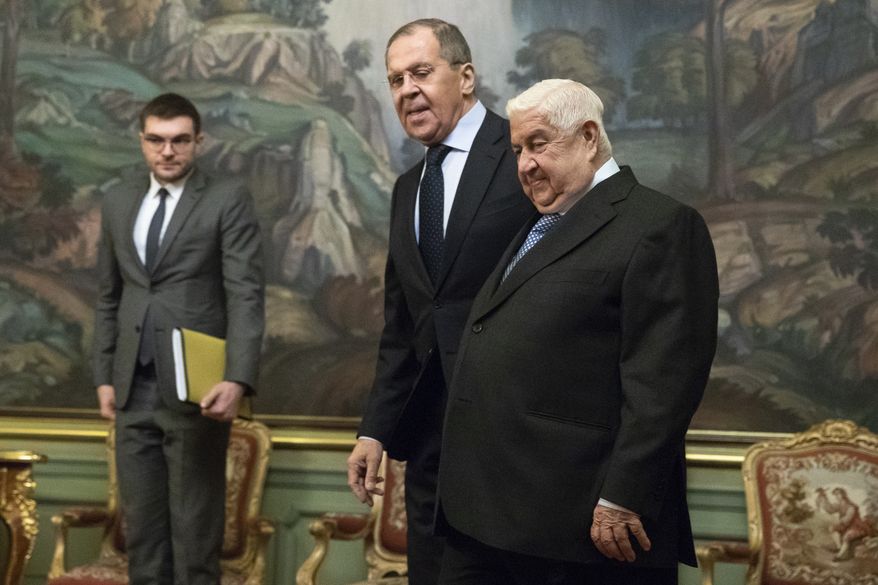 Syrian Foreign Minister Walid Muallem, right, and Russian Foreign Minister Sergey Lavrov, enter a hall during their meeting in Moscow, Russia, Monday, Dec. 23, 2019.(AP Photo/Pavel Golovkin)