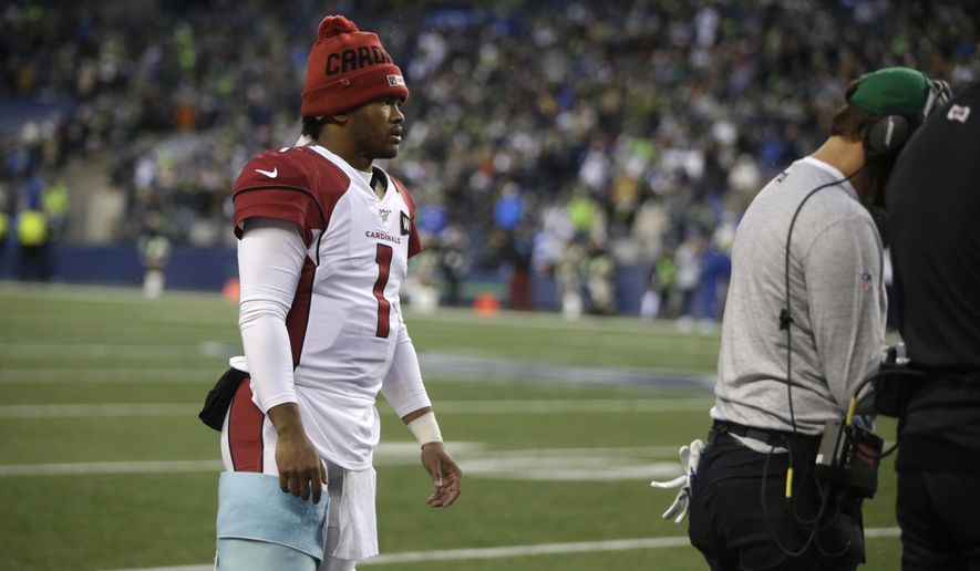 Arizona Cardinals starting quarterback Kyler Murray stands on the sideline with a wrap on his leg during the second half of an NFL football game, Sunday, Dec. 22, 2019, in Seattle. Murray left the game with an injury and was replaced by backup quarterback Brett Hundley. (AP Photo/Lindsey Wasson)