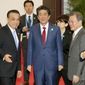 Chinese Premier Li Keqiang, left, Japan&#39;s Prime Minister Shinzo Abe, center, and South Korean President Moon Jae-in, right, walk to a photo session at the trilateral business meeting between China, South Korea and Japan in Chengdu, southwest China&#39;s Sichuan province Tuesday, Dec. 24, 2019. (Kyodo News via AP)