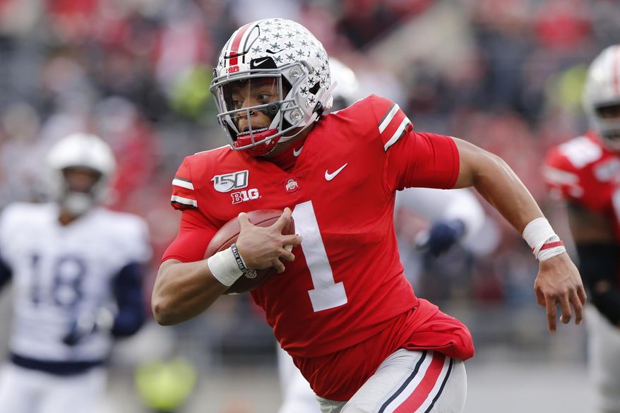 FILE - In this Nov. 23, 2019, file photo, Ohio State quarterback Justin Fields plays against Penn State during an NCAA college football game, in Columbus, Ohio. Fields, a sophomore and the Buckeyes’ Heisman Trophy finalist quarterback, said online classes allow him to split his time between studying at home or relaxing with Netflix and the Woody Hayes Athletic Center, where besides football facilities there is a new lavish lounge for players that offers made-to-order meals, massage chairs, video games on big screens and a cryogenic chamber. (AP Photo/Jay LaPrete, File)