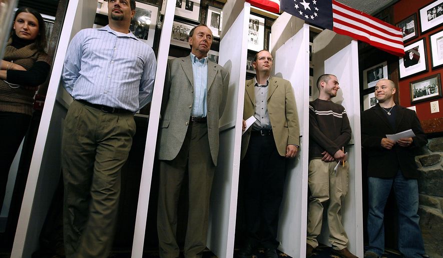 FILE - In this Nov. 4, 2008, file photo Dixville Notch residents wait for the stroke of midnight to be the first voters for the nation's presidential election in Dixville Notch, N.H. The tiny, isolated community near the Canadian border known for casting ballots just after midnight in presidential elections may need to forfeit that tradition in 2020. The attorney general's office said the community is currently missing a required official in order to hold an election in the Feb. 11 primary. (AP Photo/Cheryl Senter, File)