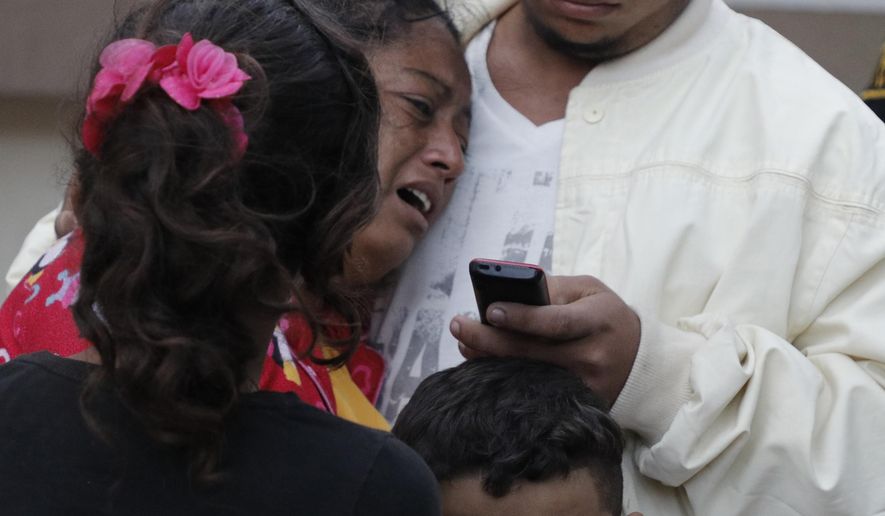 A woman cries outside the morgue after learning her husband, Dionisio Heriberto Solis, is one of the prisoners who died in a riot inside El Porvenir prison, in Tegucigalpa, Honduras, Monday, Dec. 23, 2019. At least 16 prisoners died during fighting inside a detention center in Honduras on Sunday, two days after rioting at another prison killed 18 inmates, authorities said. (AP Photo/Elmer Martinez)
