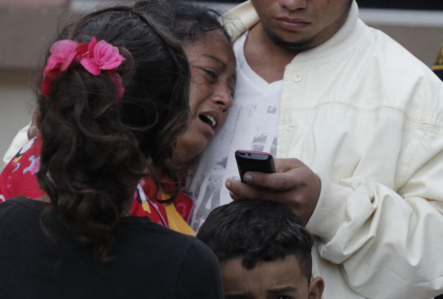 A woman cries outside the morgue after learning her husband, Dionisio Heriberto Solis, is one of the prisoners who died in a riot inside El Porvenir prison, in Tegucigalpa, Honduras, Monday, Dec. 23, 2019. At least 16 prisoners died during fighting inside a detention center in Honduras on Sunday, two days after rioting at another prison killed 18 inmates, authorities said. (AP Photo/Elmer Martinez)