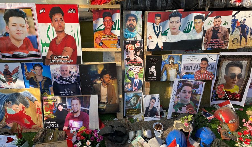 Posters of protesters who have been killed in demonstrations and their belongings are displayed in Tahrir Square during anti-government protests in Baghdad, Iraq, Sunday, Dec. 22, 2019. Thousands of protesters poured into the streets of Baghdad and Iraq's southern provinces on Sunday, rejecting the nomination of what some call an Iran-backed candidate for the prime minister's post. The demonstrations came as a midnight deadline loomed without a solution being reached to name an interim premier. (AP Photo/Khalid Mohammed)