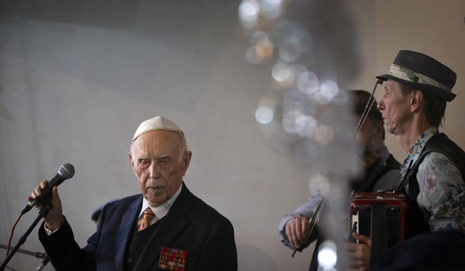Holocaust survivor and WWII veteran Mikhail Spectr, 86, pauses as he speaks during the annual Hanukkah Menorah Lighting Ceremony in Moscow, Russia, Sunday, Dec. 22, 2019. Spectr was taken to Jewry in 1941 at the age of 8 when Nazi soldiers arrived at his village in Ukraine Soviet republic. Mikhail Spectr had been kept at ghetto in Transnistria, territory between Dniester and Southern Bug, occupied by the Nazi and its allies from 1941 and 1944. (AP Photo/Alexander Zemlianichenko)
