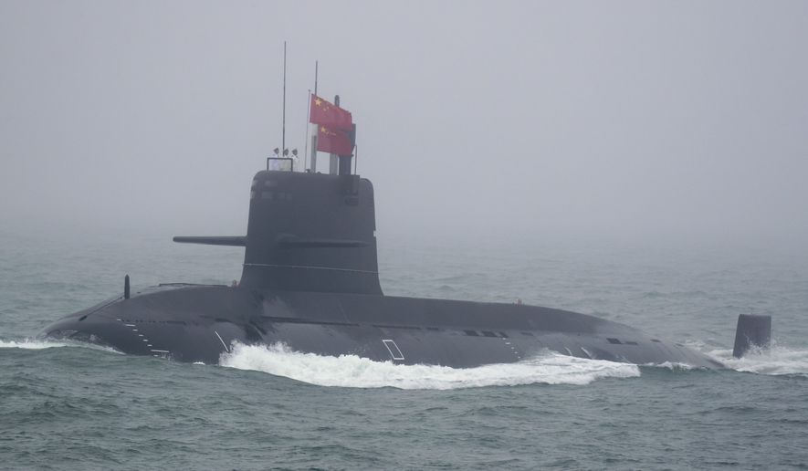 A Great Wall 236 submarine of the Chinese People&#39;s Liberation Army (PLA) Navy, billed by Chinese state media as a new type of conventional submarine, participates in a naval parade to commemorate the 70th anniversary of the founding of China&#39;s PLA Navy in the sea near Qingdao in eastern China&#39;s Shandong province, Tuesday, April 23, 2019. (AP Photo/Mark Schiefelbein, Pool)