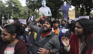 Students shout slogans against government during a protest against new citizenship law in New Delhi, India, Tuesday, Dec. 24, 2019. Hundreds of students marched Tuesday through the streets of New Delhi to Jantar Mantar, an area designated for protests near Parliament, against the new citizenship law, that allows Hindus, Christians and other religious minorities who are in India illegally to become citizens if they can show they were persecuted because of their religion in Muslim-majority Bangladesh, Pakistan and Afghanistan. It does not apply to Muslims. (AP Photo/Manish Swarup) **FILE**