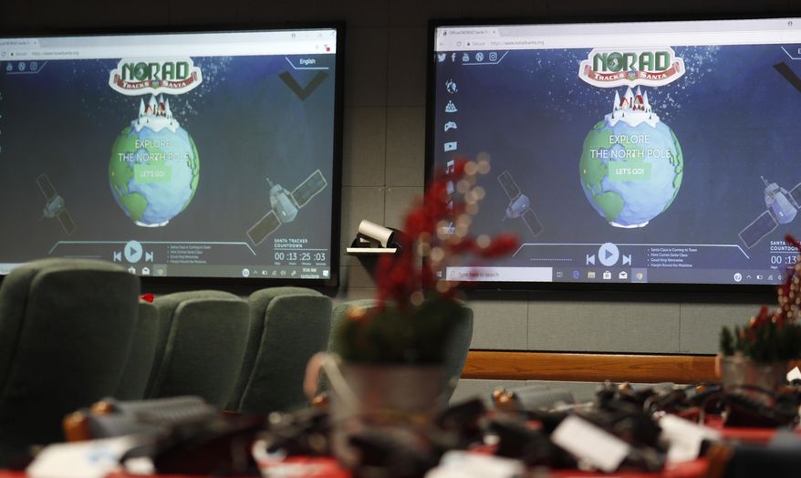 Monitors are illuminated in the NORAD Tracks Santa center at Peterson Air Force Base, Monday, Dec. 23, 2019, in Colorado Springs, Colo. More than 1,500 volunteers will answer an estimated 140,000 telephone calls from childfren and their parents who will be checking on the whereabouts of Santa Clau on Christmas Eve. (AP Photo/David Zalubowski)