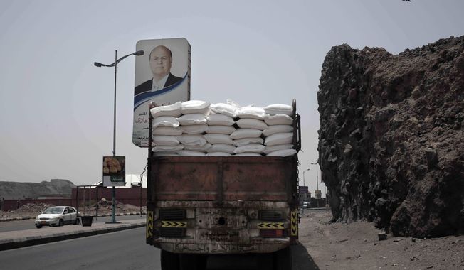 FILE - In this July 23, 2018 file photo, a truck carries aid on a road in Aden, Yemen. The U.N. says that a dozen humanitarian organizations in war-torn southern Yemen have suspended their work after a string of targeted attacks. Meanwhile, the country&#x27;s rebel-led health ministry announced on Tuesday, Dec. 24, 2019, that severe outbreaks of swine flu and dengue fever have killed close to 200 people since October. (AP Photo/Nariman El-Mofty, File)