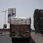 FILE - In this July 23, 2018 file photo, a truck carries aid on a road in Aden, Yemen. The U.N. says that a dozen humanitarian organizations in war-torn southern Yemen have suspended their work after a string of targeted attacks. Meanwhile, the country&#39;s rebel-led health ministry announced on Tuesday, Dec. 24, 2019, that severe outbreaks of swine flu and dengue fever have killed close to 200 people since October. (AP Photo/Nariman El-Mofty, File)