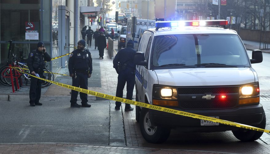 In this Monday morning, Feb. 4, 2019, file photo, Baltimore Police block off Penn Street at Lombard after a shooting at the University of Maryland Medical Center Shock Trauma in Baltimore. The hospital went on lockdown Monday after a 24-year-old employee was critically wounded by a gunman near an ambulance bay at the University of Maryland Medical Center. Baltimore could wrap up 2019 with its highest per-capita homicide rate on record as killings of adults and minors alike for drugs, retribution, money or no clear reason continue to add up and city officials appear unable to stop the violence. (Jerry Jackson/The Baltimore Sun via AP)