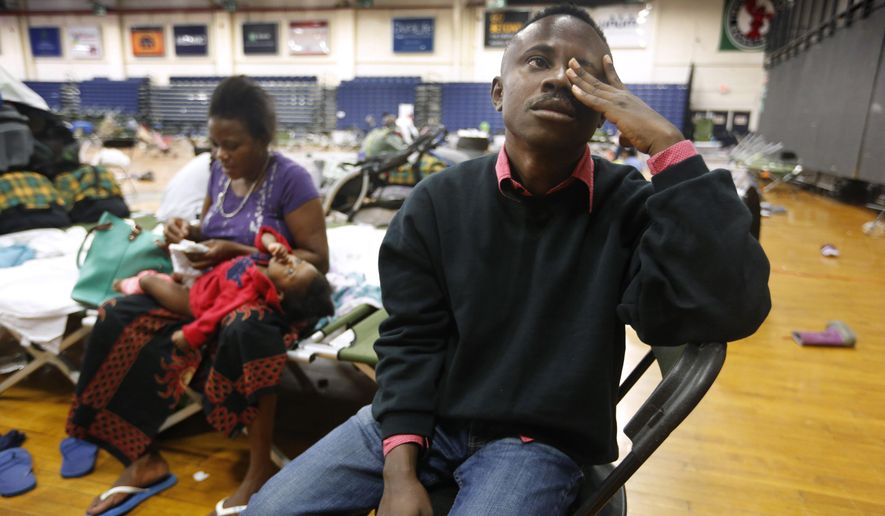 In this Aug. 15, 2019, file photo, Thierry Malasa pauses while describing the harrowing journey that led his family from the Congo to Maine, as the family prepared to move out of the Portland Expo, in Portland, Maine. The state's largest city raced to find homes for dozens of African asylum seekers as the temporary shelter closed. On Jan. 2, 2020, a Maine developer came forward with plans to use a former monastery to house newly arrived asylum seekers. (AP Photo/Robert F. Bukaty, File) **FILE**