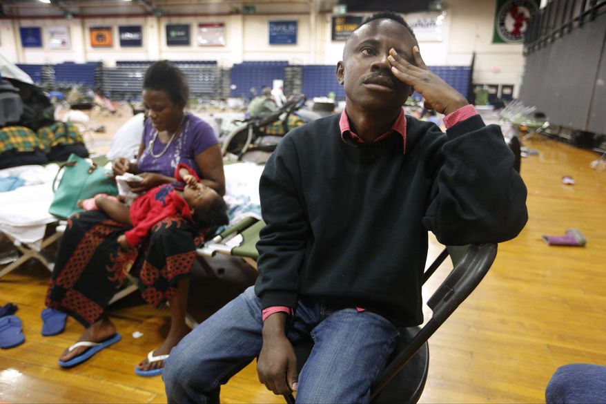 In this Aug. 15, 2019, file photo, Thierry Malasa pauses while describing the harrowing journey that led his family from the Congo to Maine, as the family prepared to move out of the Portland Expo, in Portland, Maine. The state's largest city raced to find homes for dozens of African asylum seekers as the temporary shelter closed. On Jan. 2, 2020, a Maine developer came forward with plans to use a former monastery to house newly arrived asylum seekers. (AP Photo/Robert F. Bukaty, File) **FILE**