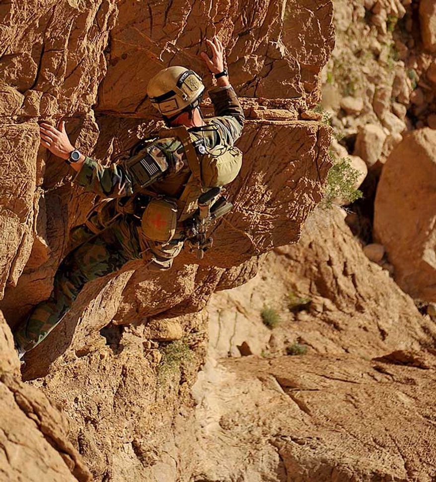 A MARSOC Marine climbs down the side of a mountain during a dismounted patrol through some mountains east of highway one during a three-day combat reconnaissance patrol in Farah Prov., Bala Baluk District, Afghanistan, March 31. The coalition forces started the three-day CRP lead by the ANA with a dismounted patrol through Suji, Peyo and Pasaw, an air drop of humanitarian aide supplies for Aka Sadiq and a route recon through the mountainous terrain of eastern Bala Baluk. (U.S. Air Force photo/Staff Sergeant Nicholas Pilch)