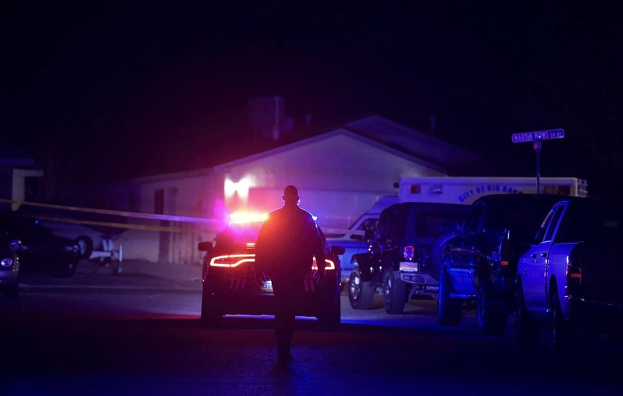 Authorities work the scene where multiple people were found dead in a home in the Northern Meadows subdivision, Wednesday, Dec. 25, 2019, in Rio Rancho, N.M. (Roberto E. Rosales/The Albuquerque Journal via AP)