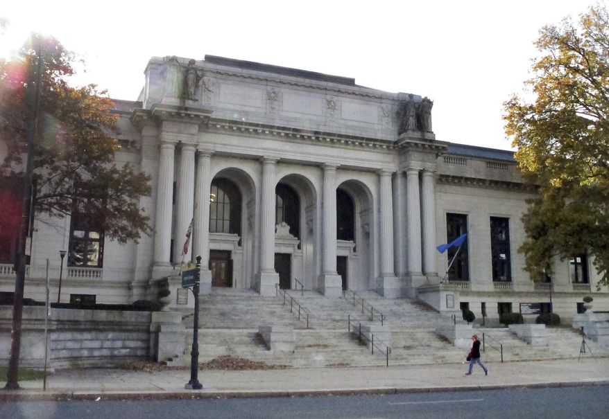 FILE— In this Nov. 27, 2017 file photograph, a person walks past the Supreme Court building, in Hartford, Conn. The Connecticut court system will usher in the new year by moving required public notices to its website and out of newspapers, citing lower costs and the potential to be more effective in notifying people about important legal matters. (AP Photo/Dave Collins)