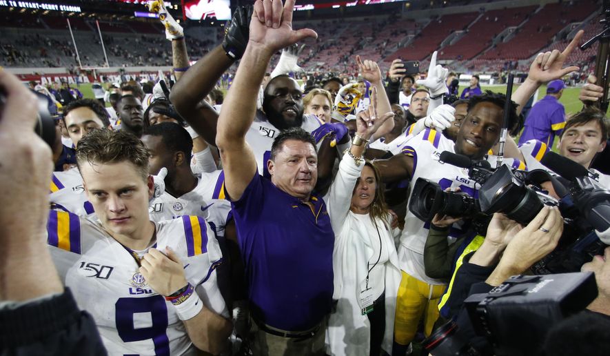 FILE - In this Nov. 9, 2019, file photo, LSU head coach Ed Orgeron celebrates with his players after defeating Alabama 46-41 in an NCAA college football game in Tuscaloosa, Ala. (AP Photo/John Bazemore, File)