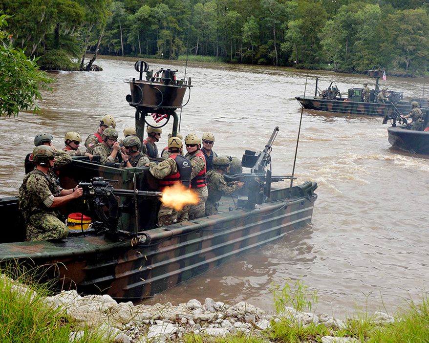 Lt. Gen Kenneth Tovo, commanding general of U.S. Army Special Operations Command (USASOC), participates in a simulated hot extraction by Special Boat Team 22 from Naval Special Warfare (NSW) Group 4, at the John C. Stennis Space Center. Tovo's visit to the three Stennis NSW commands marks his first tour of the area as commander of USASOC. (U.S. Navy photo by Leah Tolbert/Released)170725-N-JK586-025