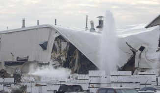 Authorities respond after a partial building collapse at Beechcraft aircraft manufacturing facility in Wichita, Kan., Friday, Dec. 27, 2019. More than a dozen people were injured Friday when a nitrogen line ruptured at the facility, causing part of the building to collapse, authorities said. (Travis Heying/The Wichita Eagle via AP)