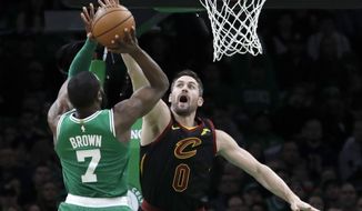 Boston Celtics guard Jaylen Brown (7) shoots against Cleveland Cavaliers forward Kevin Love (0) in the first half of an NBA basketball game, Friday, Dec. 27, 2019, in Boston. (AP Photo/Elise Amendola)