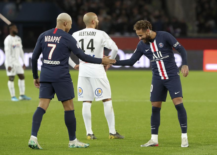 PSG&#39;s Kylian Mbappe, left, and Neymar celebrate after scoring their side&#39;s third goal during the League One soccer match between Paris Saint Germain and Amiens, at the Parc des Princes stadium in Paris, Saturday, Dec. 21, 2019. (AP Photo/Thibault Camus)