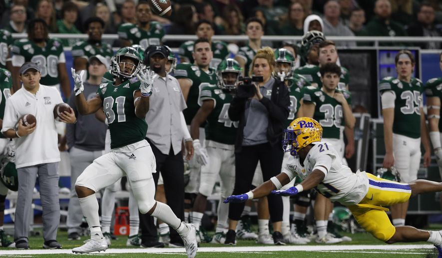Eastern Michigan wide receiver Quian Williams (81), defended by Pittsburgh defensive back Damarri Mathis (21), catches a pass and runs for 50-yards for a touchdown during the first half of the Quick Lane Bowl NCAA college football game, Thursday, Dec. 26, 2019, in Detroit. (AP Photo/Carlos Osorio)