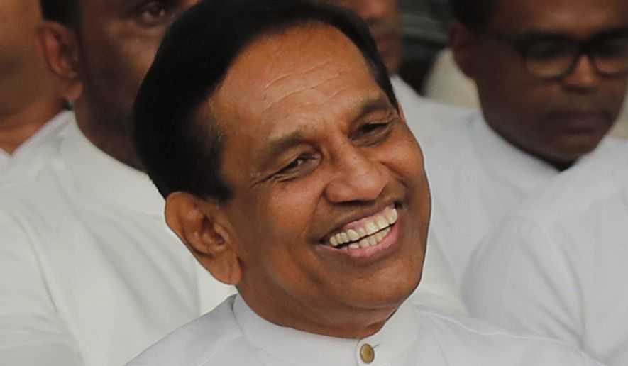 In this Monday, Dec. 23, 2019, photo, former Cabinet minister Rajitha Senaratne participates in a protest in Colombo, Sri Lanka. Sri Lankan police arrested the hospitalized former Cabinet minister on Friday, Dec. 27, for alleged involvement in organizing a news conference about abductions under the government of the current president's brother. Lawyer Gunaratna Wanninayake said Senarathna, now an opposition lawmaker, was arrested at a private hospital where he was admitted on Thursday. (AP Photo/Eranga Jayawardena)