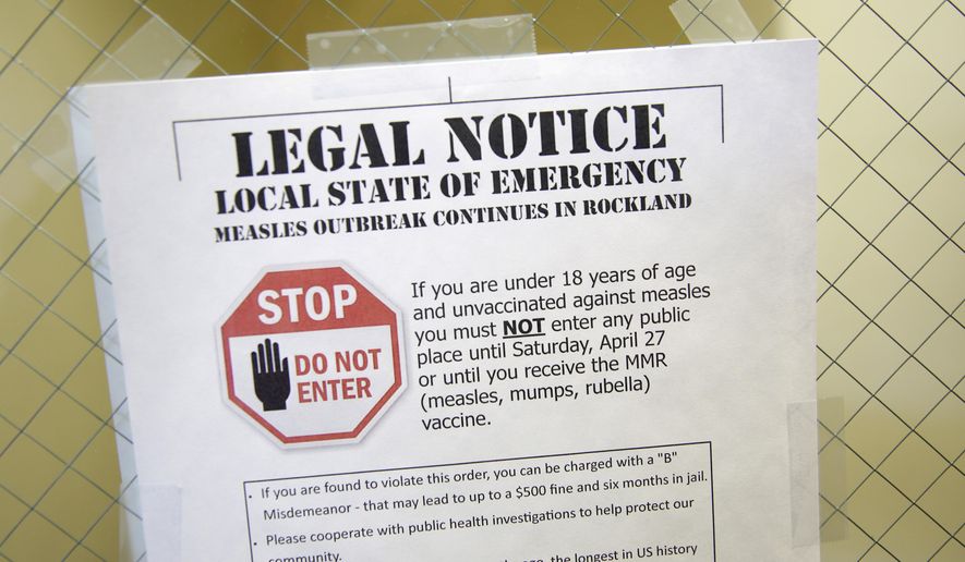 FILE - In this Wednesday, March 27, 2019 file photo, a sign at the Rockland County Health Department in Pomona, N.Y., explains the local state of emergency regarding a measles outbreak. There were nearly 1,300 case of measles in the U.S. through November 2019 - the largest number in 27 years. There were no deaths but about 120 people ended up in the hospital. (AP Photo/Seth Wenig)