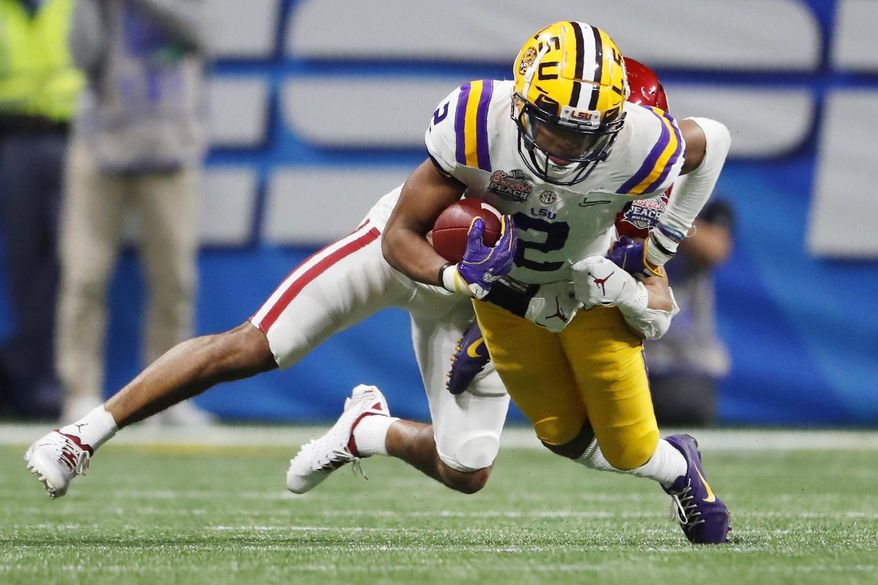 LSU wide receiver Justin Jefferson (2) runs against Oklahoma cornerback Woodi Washington (5) during the second half of the Peach Bowl NCAA semifinal college football playoff game, Saturday, Dec. 28, 2019, in Atlanta. LSU won 63-28. (AP Photo/John Bazemore)